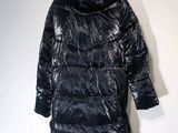 an image of a shiny black jacket on a mannequin stand