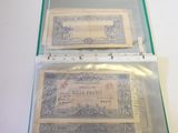 two bills in a clear case on a table
