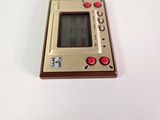 a small electronic device sitting on a white surface