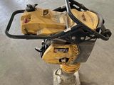a close up of a small machine on a stand in a warehouse