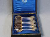 a box with a set of silver spoons and spoons in it