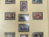 an old picture of a collection of stamps on display in a frame