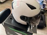 a helmet sitting on top of a chair in a room
