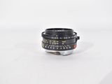 an old camera lens on a white surface with a white background