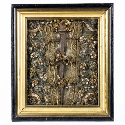 a gold and black framed picture of flowers and leaves