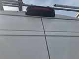 a white van with a suitcase on top of it
