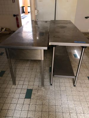 two tables that are sitting in a kitchen