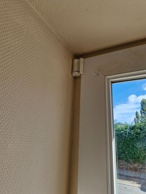 a small window in the corner of a room
