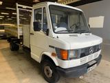 a white truck that is parked in a garage