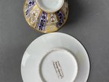 an image of a cup and saucer sitting on top of a table