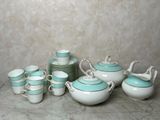 a lot of tea cups and saucers sitting on a table