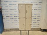 three metal lockers on a metal stand in front of a wall