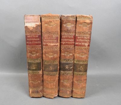 three old books sitting on top of each other on a gray surface