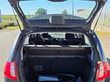 the back of a car with its trunk open on the side of the road