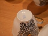 a close up of a cup and saucer on a table