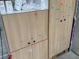 two wooden cabinets in a room with boxes on top of them