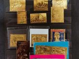 a bunch of gold and silver cards on display in a glass case