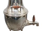 a silver tea pot with a wooden handle on a stand