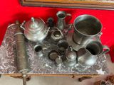 a table that has a bunch of silver items on it