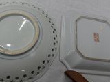 a white plate with a brown handle and a white plate with a brown handle