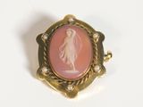 an image of a pink and gold broochle with a lady on it