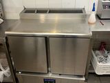 un plan de travail en inox équipé de deux éviers et d'un grille-pain