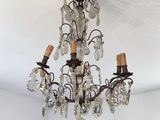 chandelier in the corner of a room with white walls and ceiling