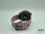 the watch is pink and has a black band on it