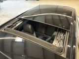 a car that is sitting in a garage with the sunroof