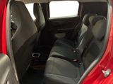 the interior of a red car with two rows of seats in it