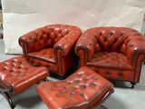 a red leather chair and ottoman in a room