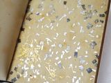 a open book with gold and silver confetti on it