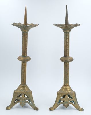 pair of antique brass candlesticks with ornate designs on each end