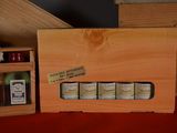 a wooden box with six bottles of liquor in it