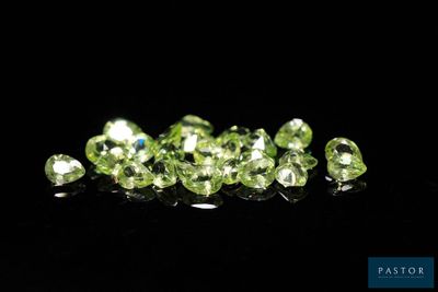 a bunch of green diamonds on a black surface