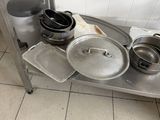 many pots and pans sitting on a stainless steel table