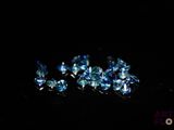 some very pretty blue diamonds sitting on top of a black surface