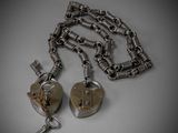 two heart shaped keys are attached to a chain with a lock