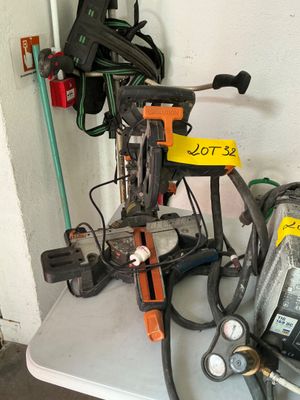 a pile of tools on a table in a garage
