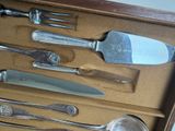 a lot of silverware in a box on the table