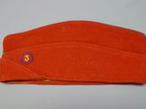 an orange hat with the number 35 on it is laying on a table