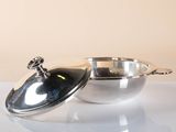 a silver bowl with a lid sitting on a table