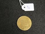 a close up of a gold coin with a price tag on it