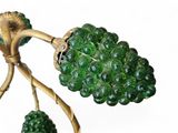 a close up of a green glass flower on a branch