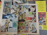 a comic book open on a table with comics on it