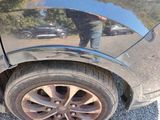 a man standing in front of a car with a reflection on the side of it