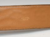 a close up of a brown belt with a gold buckle