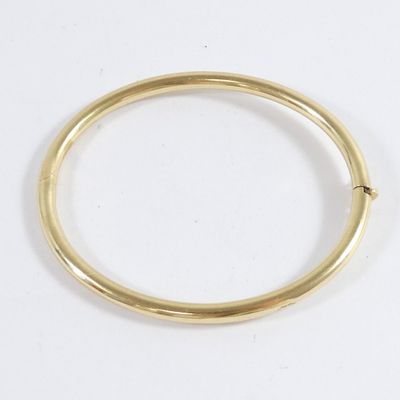 a close up of a gold ring on a white surface