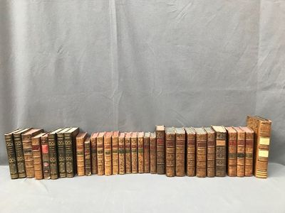 a stack of old books sitting on top of a white table