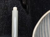 a small white object in the lapel of a jacket